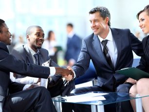 a group of business people shaking hands.